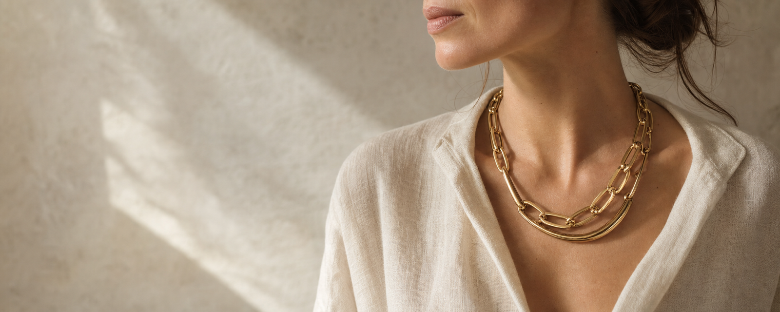 Woman wearing a sculptural gold necklace